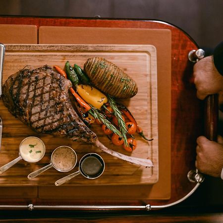 Al Habtoor Palace - Preferred Hotels & Resorts Dubai Exterior photo A steak prepared on a serving cart